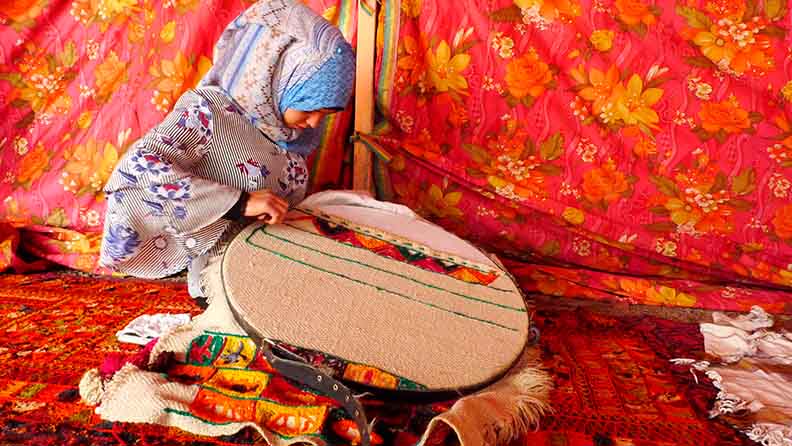 Young Qudher girl learning to embroider